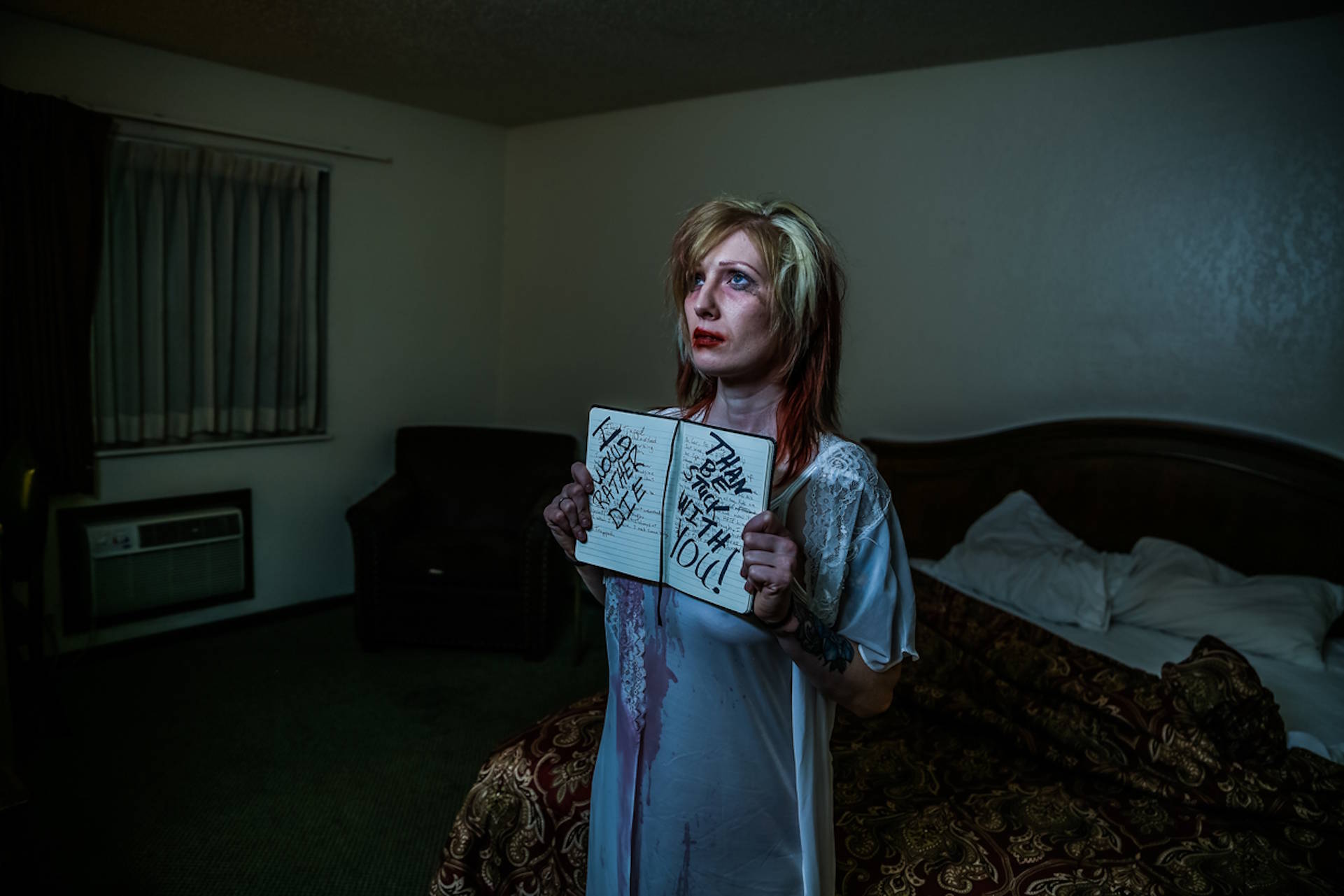 bruised woman holding sad notes