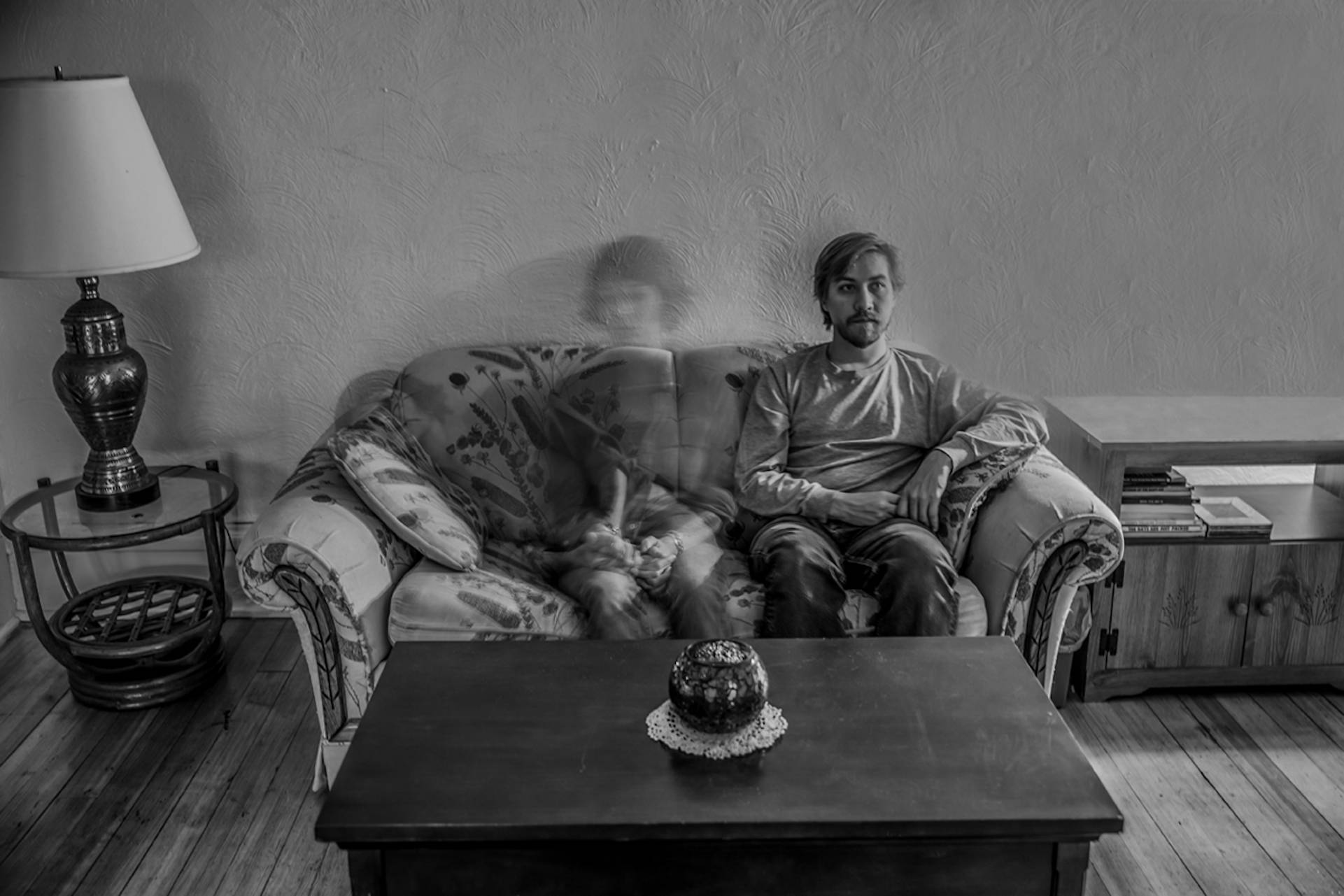 Woman's shadow sitting next to man on couch representing being in a relationship and feeling invisible and unheard.